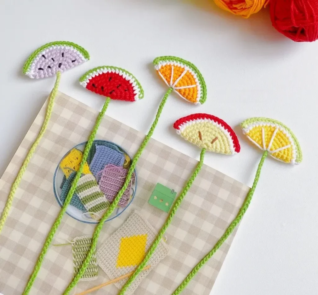 Crochet fruit bookmarks, watermelon, orange, and lemon slices.