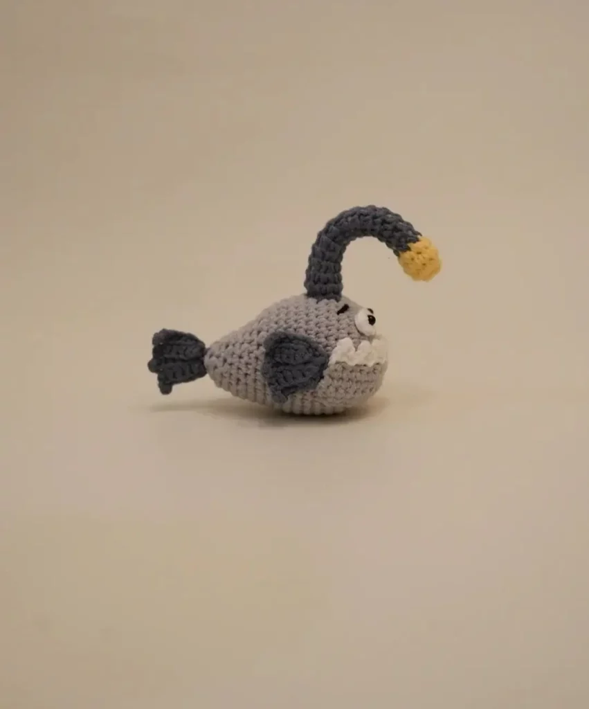 Crochet anglerfish toy, gray and light gray.