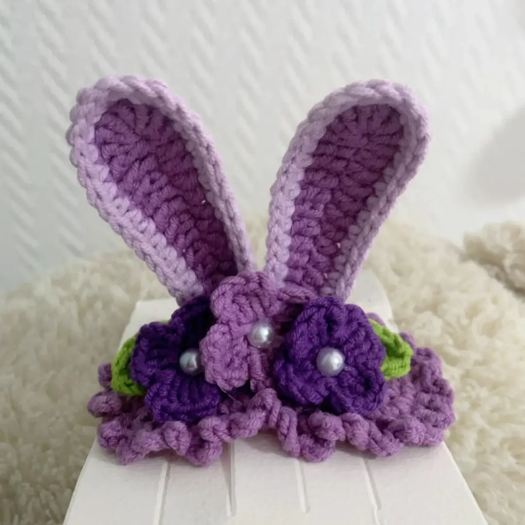 Crocheted purple bunny ears with flowers, beads.