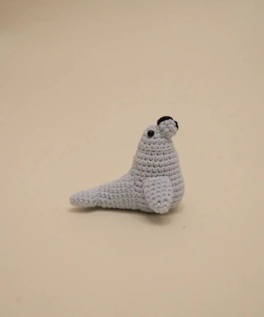 Crocheted light gray seal figurine.