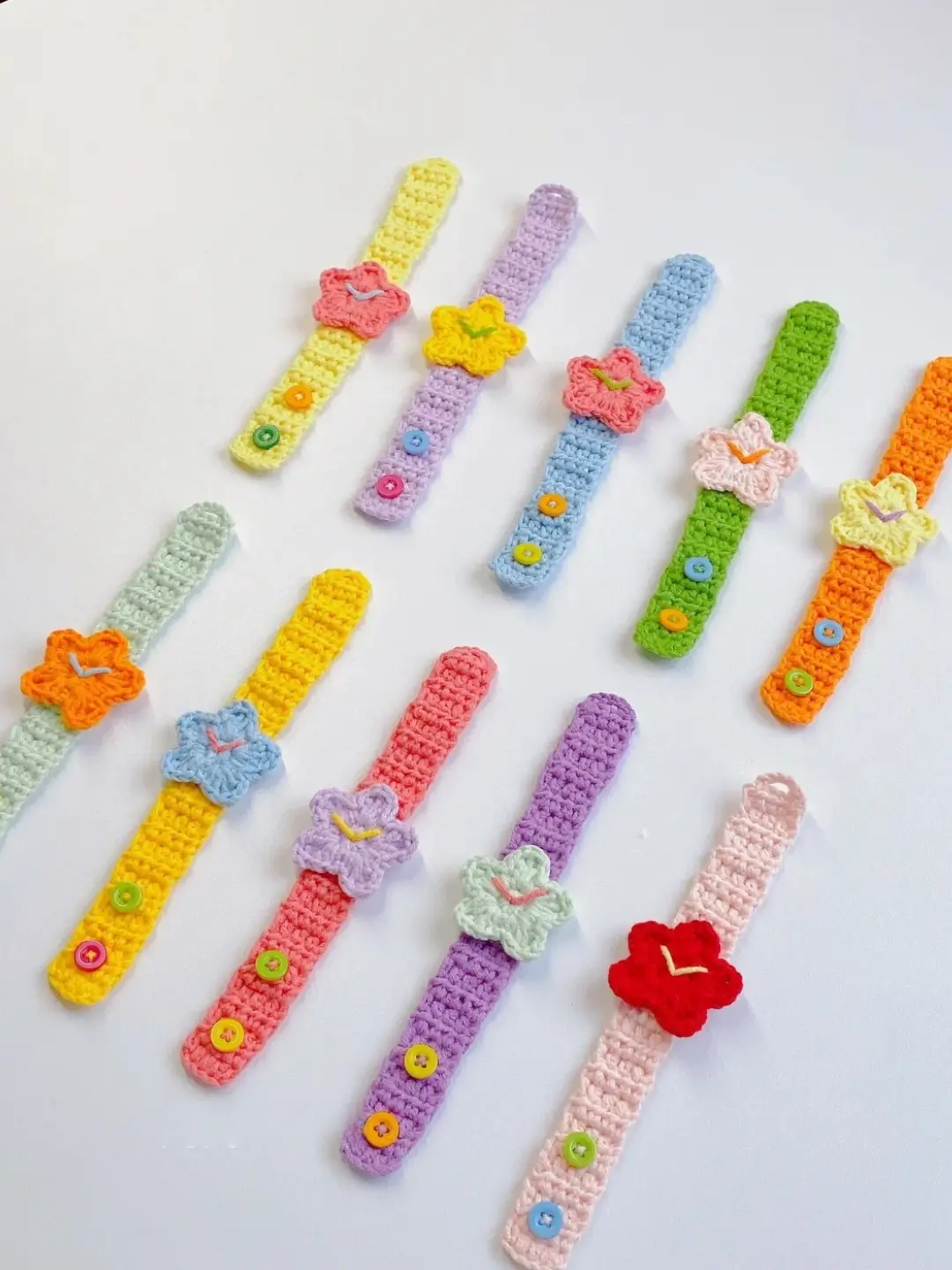 Colorful crocheted wristbands with flower appliqués.