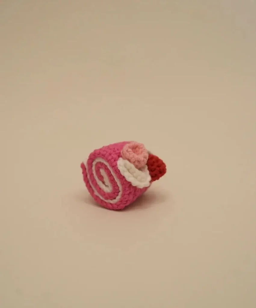 Pink crochet roll cake.  Sweet treat.