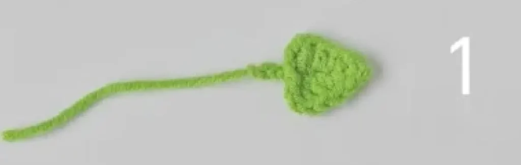Crocheted lime green flower petal, step 1.