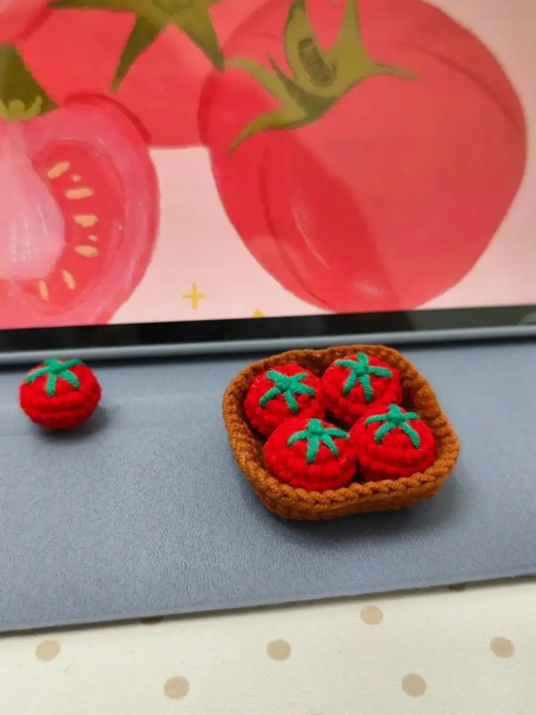 Crocheted tomatoes in a basket.  Small, red tomatoes.  Handmade.