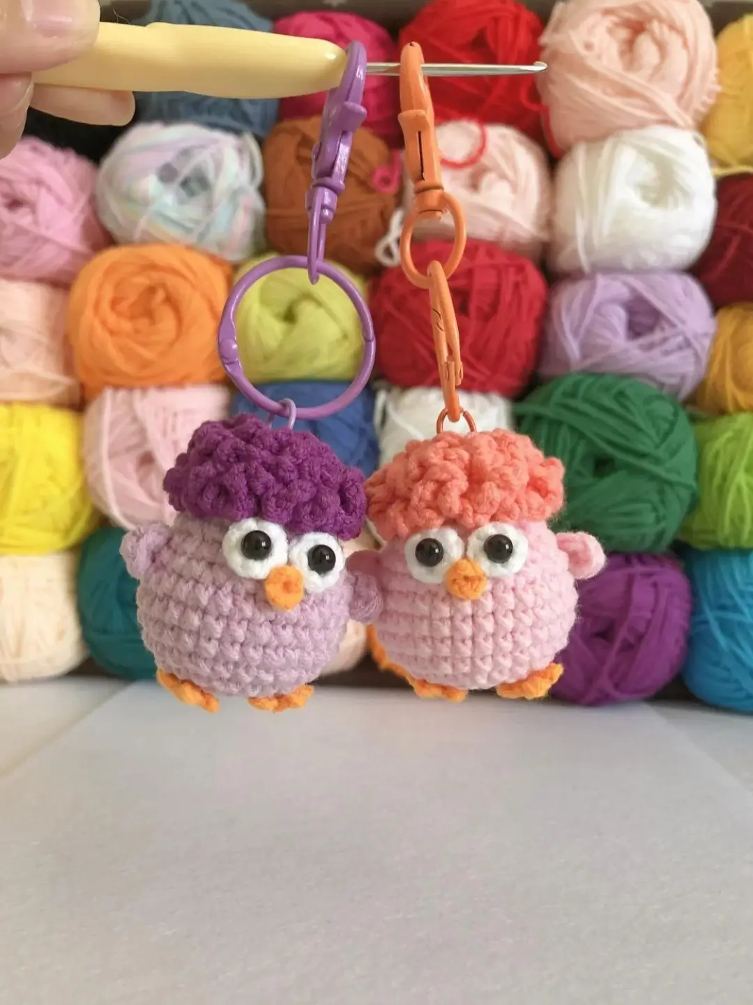 Crochet bird keychains, purple and orange.