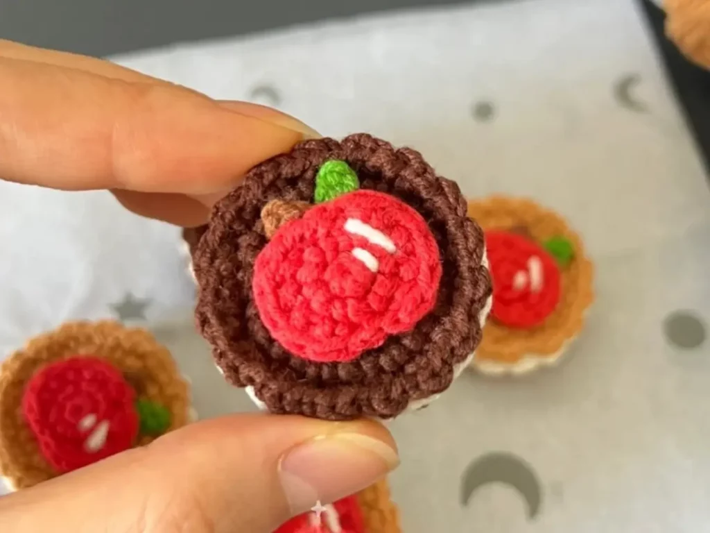 Crocheted apple dessert, miniature cookie.