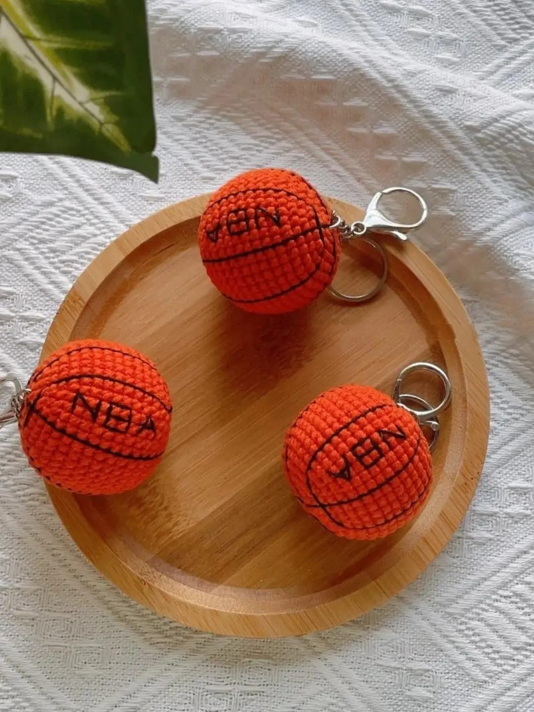 Three crocheted orange basketball keychains.