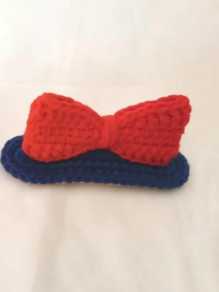 Crocheted red and navy bow, baby booties.