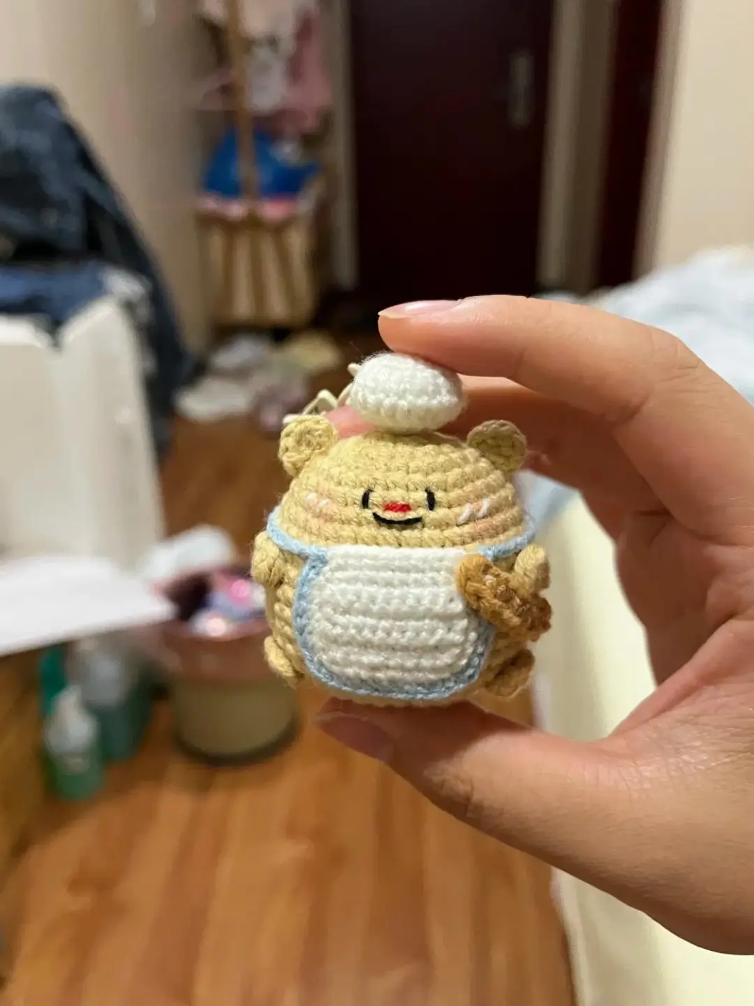 Crochet bear wearing an apron.  Cute stuffed animal.