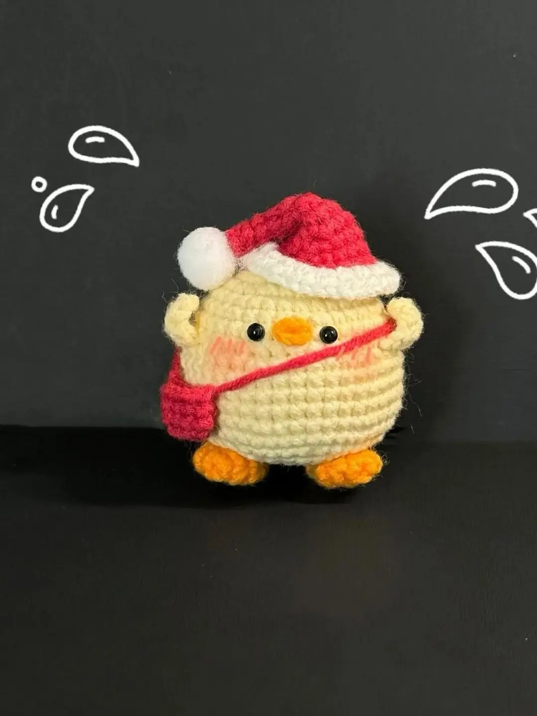 Cute crocheted chick wearing a Santa hat.  Christmas amigurumi.