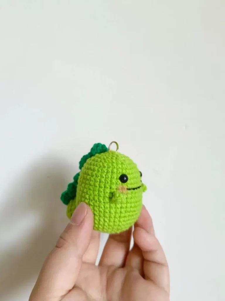 Cute green crochet dinosaur keychain.