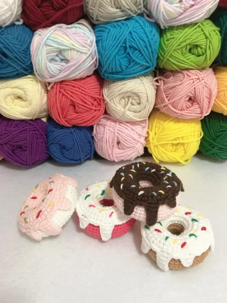 Crocheted donuts, colorful yarn balls.