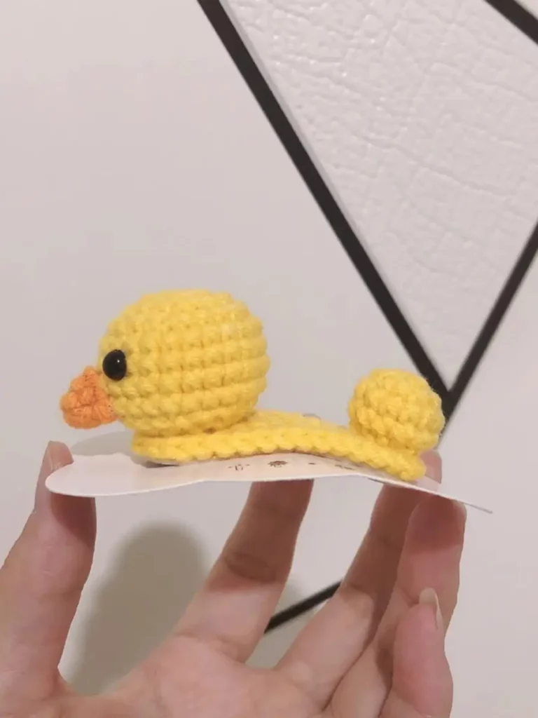 Yellow crocheted duck hair clip.