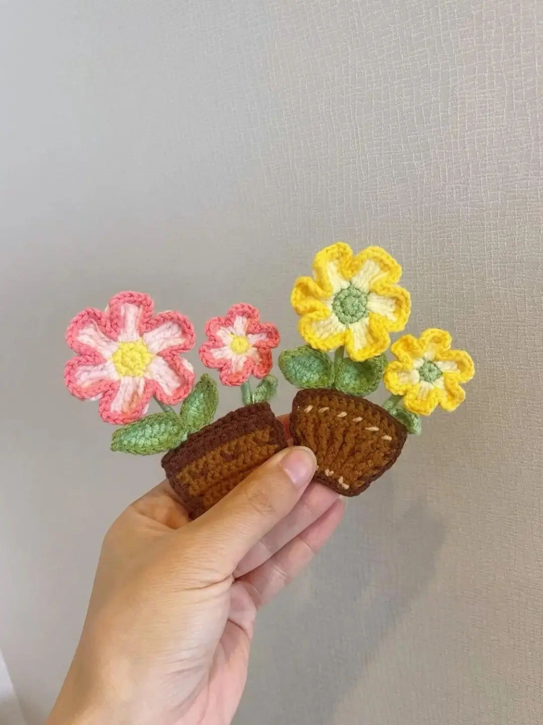Crocheted flower pots, pink & yellow flowers, handmade decor.