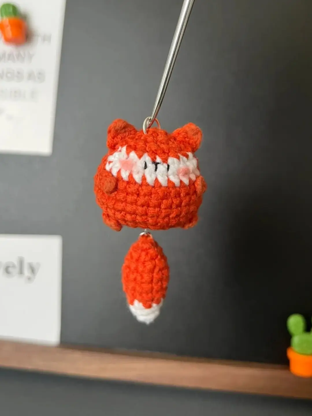 Crocheted orange fox keychain.