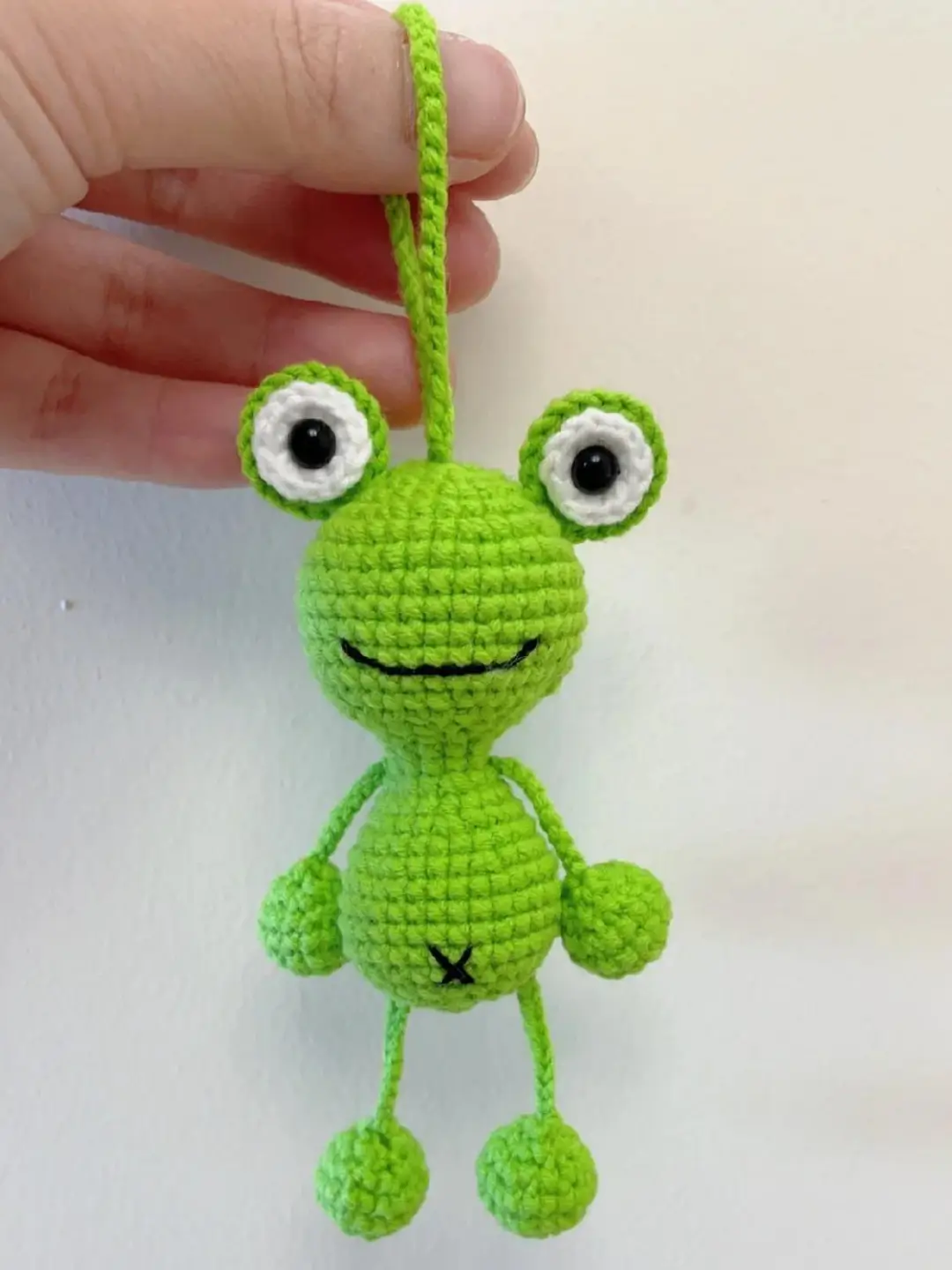 Crocheted green frog keychain.