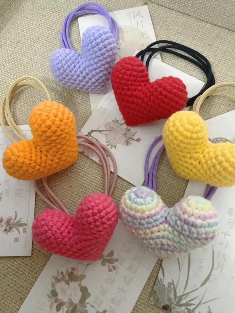 Crocheted heart-shaped hair ties in various colors.
