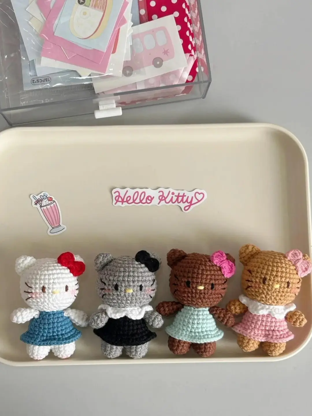 Four crochet Hello Kitty toys, various colors.