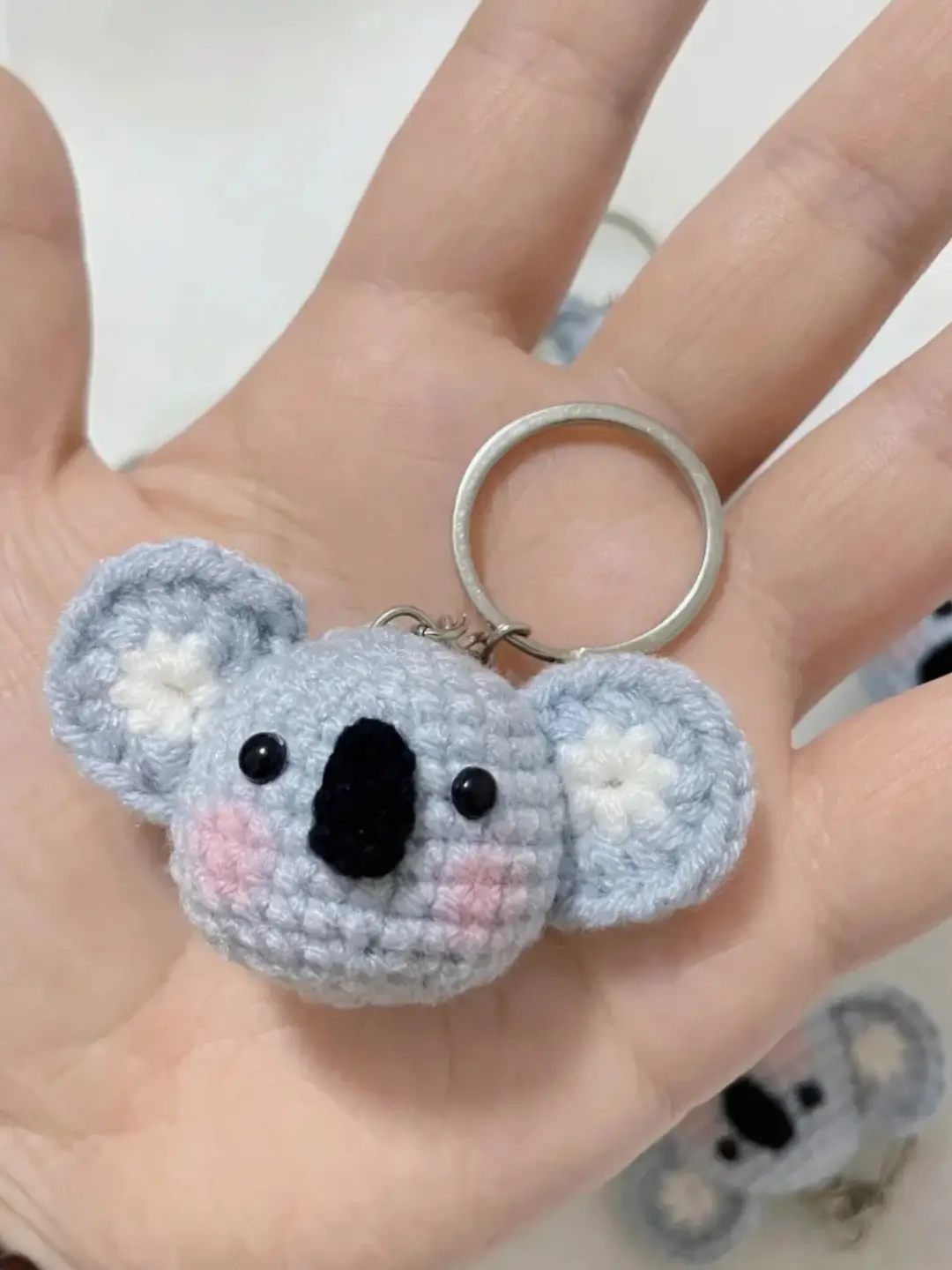 Crocheted koala keychain, light gray,  pink accents.