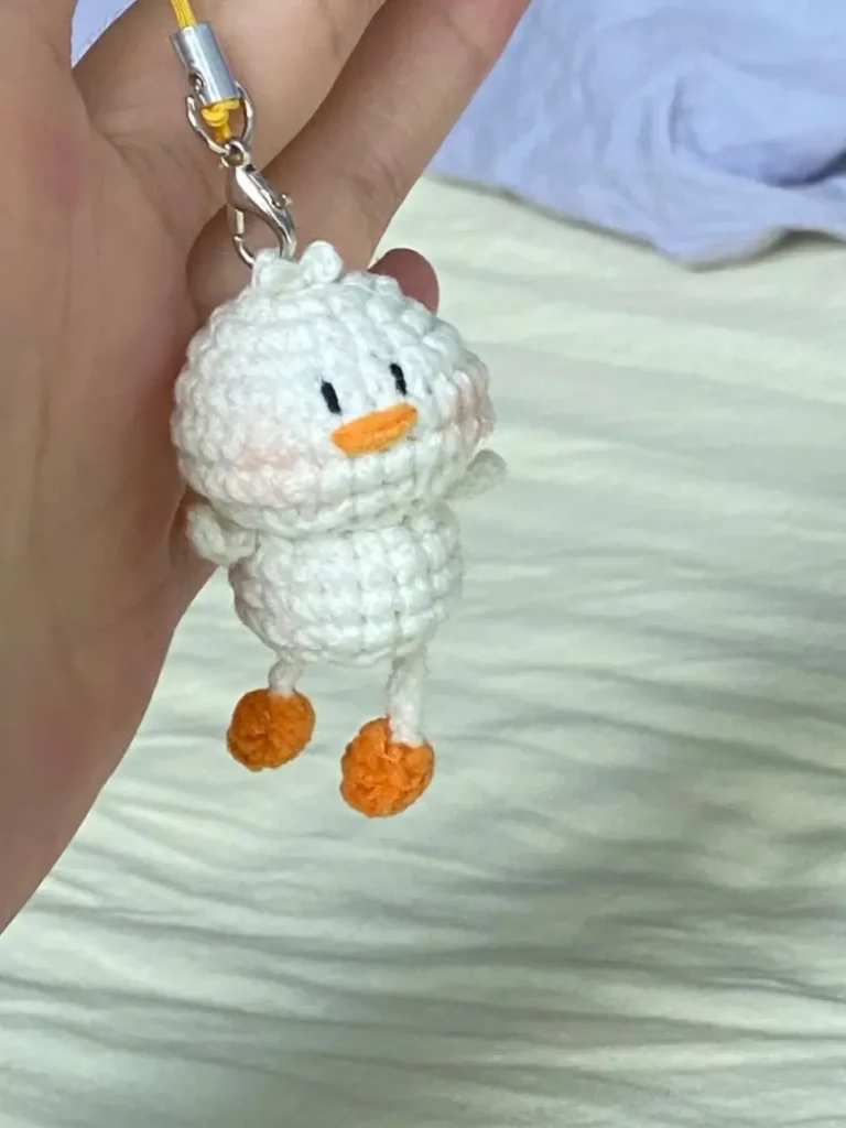 White crocheted chick keychain.