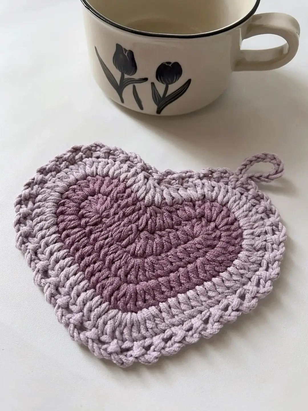 Crocheted heart-shaped coaster,  purple ombre.