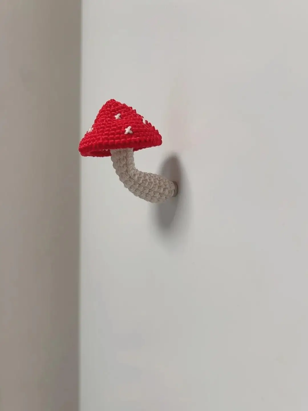 Small crocheted red mushroom wall hook.