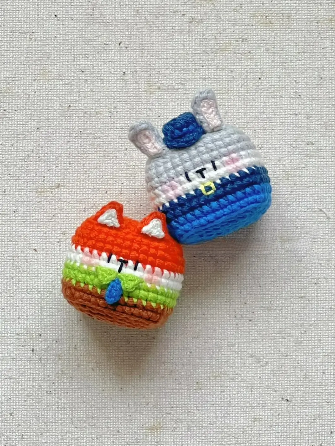 Crocheted animal figurines, fox and rabbit, in colorful designs.