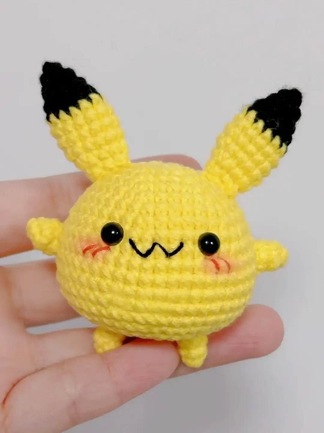 Cute yellow crocheted Pikachu amigurumi.