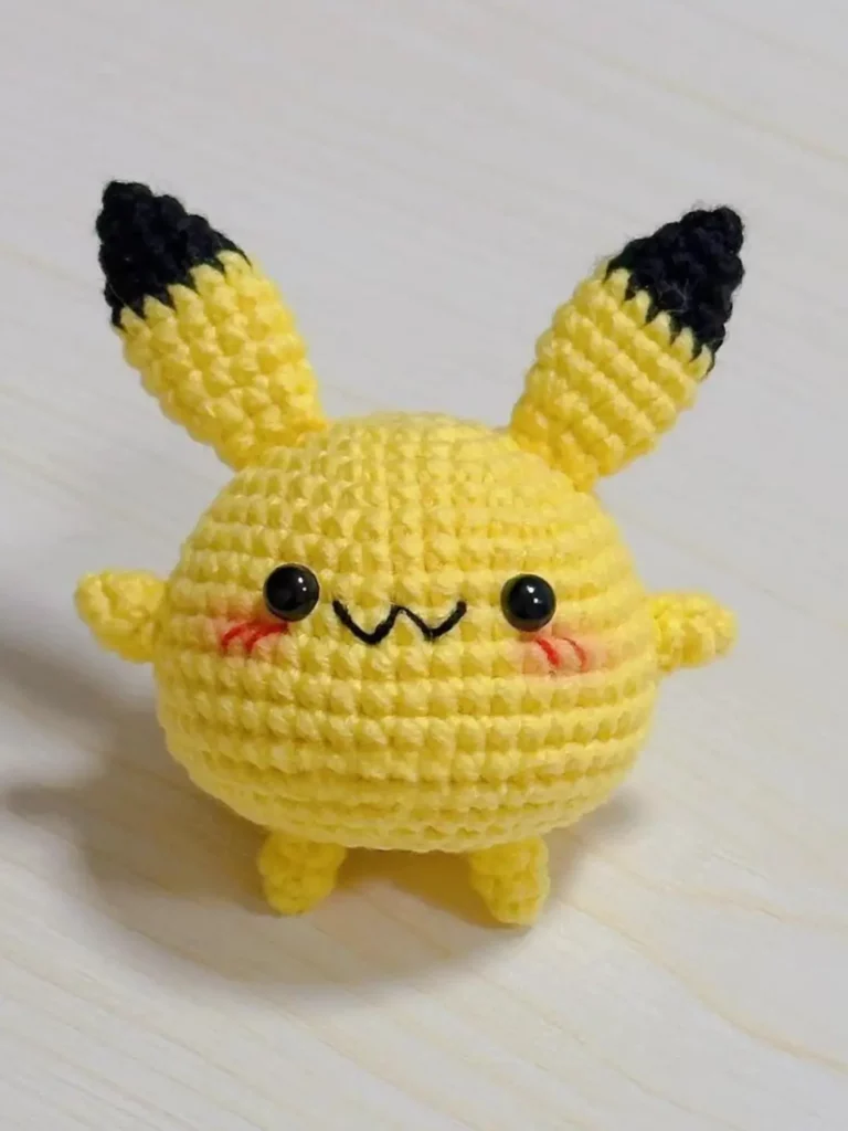 Cute yellow amigurumi Pikachu.  Crochet.  Small toy.