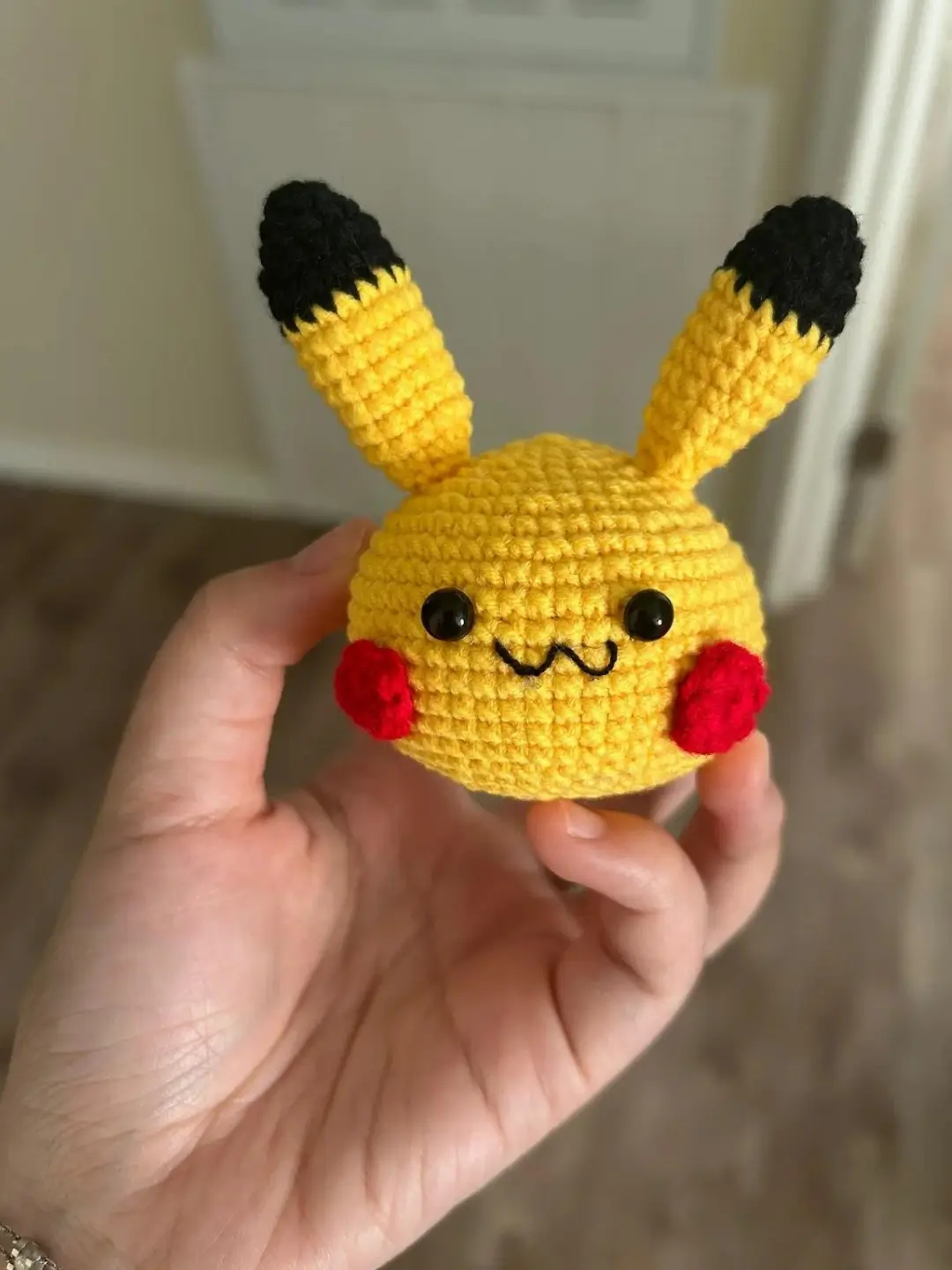 Crochet Pikachu, yellow, black ears, red cheeks.
