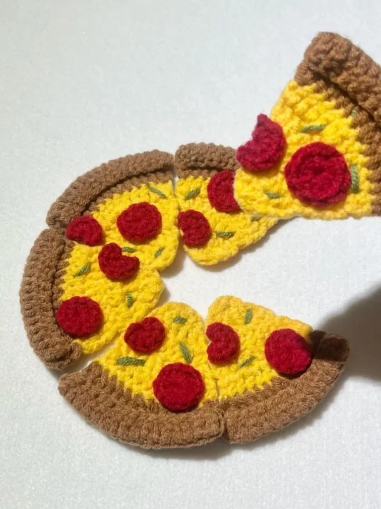 Crocheted pizza slices, pepperoni toppings.