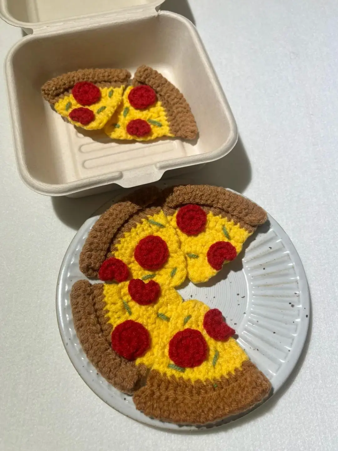 Crocheted pizza slices, food art.