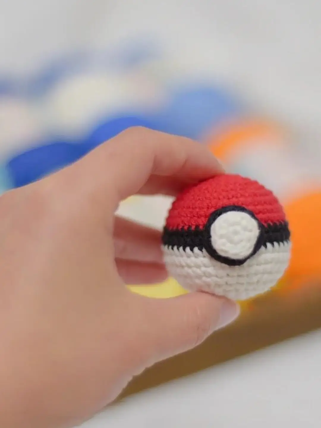 Crocheted Pokémon Poké Ball, red and white.