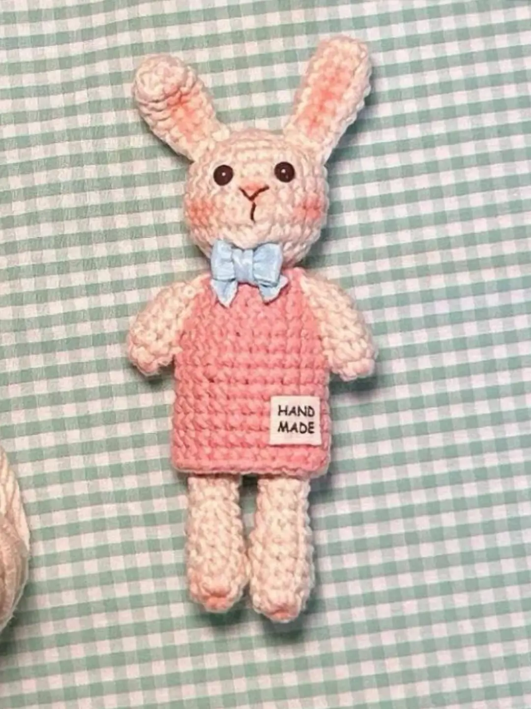 Handmade crochet bunny toy, pink dress, light beige.