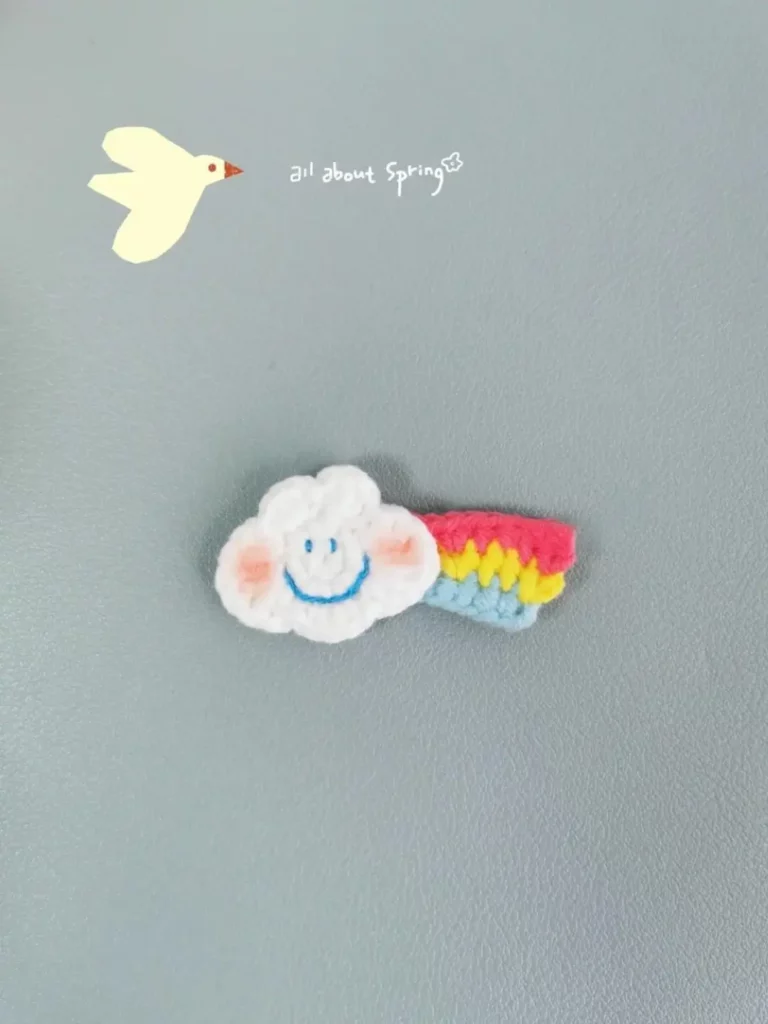 Crocheted cloud and rainbow, spring theme.
