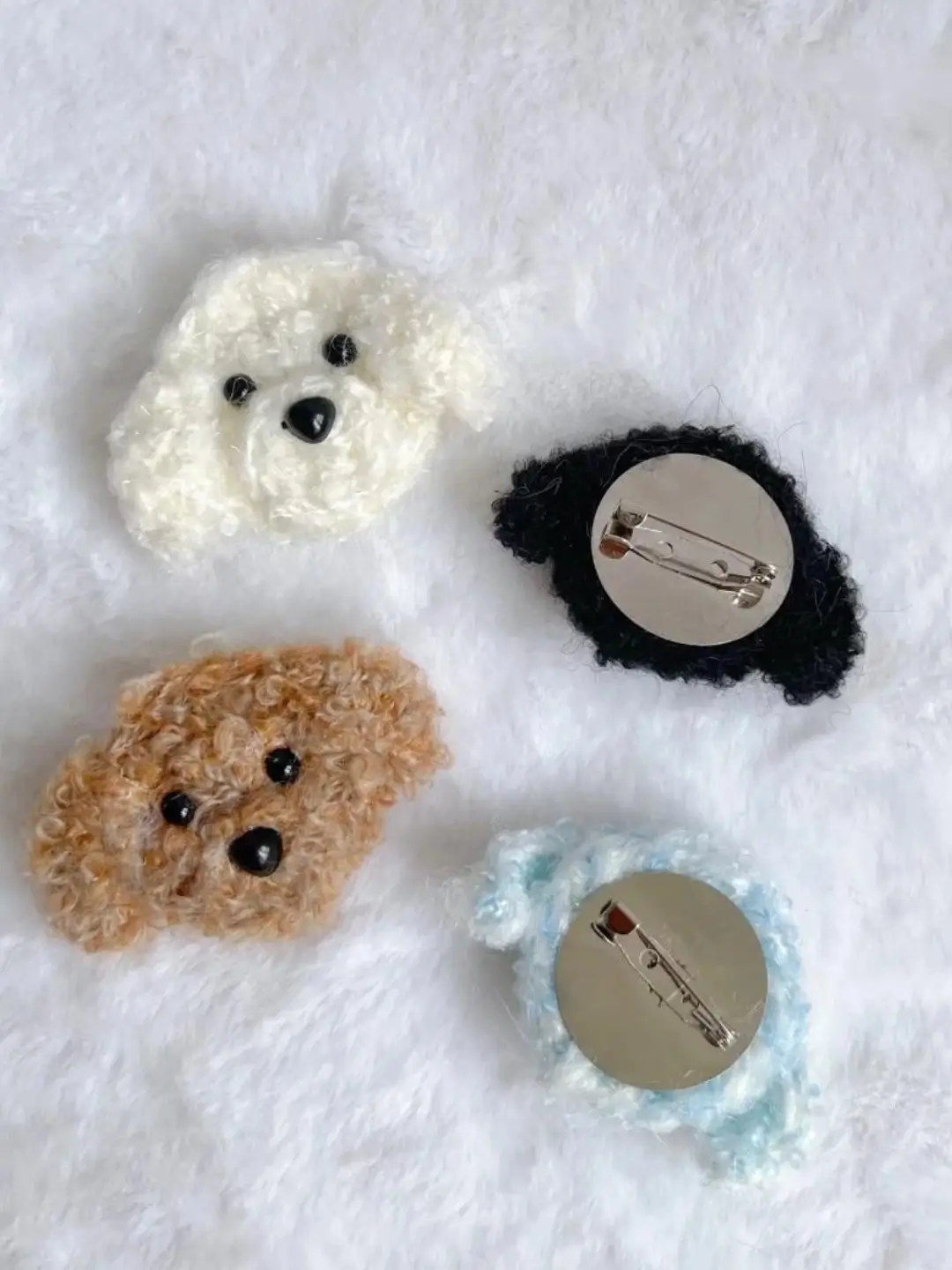 Crochet dog brooches, white, brown, black, light blue.