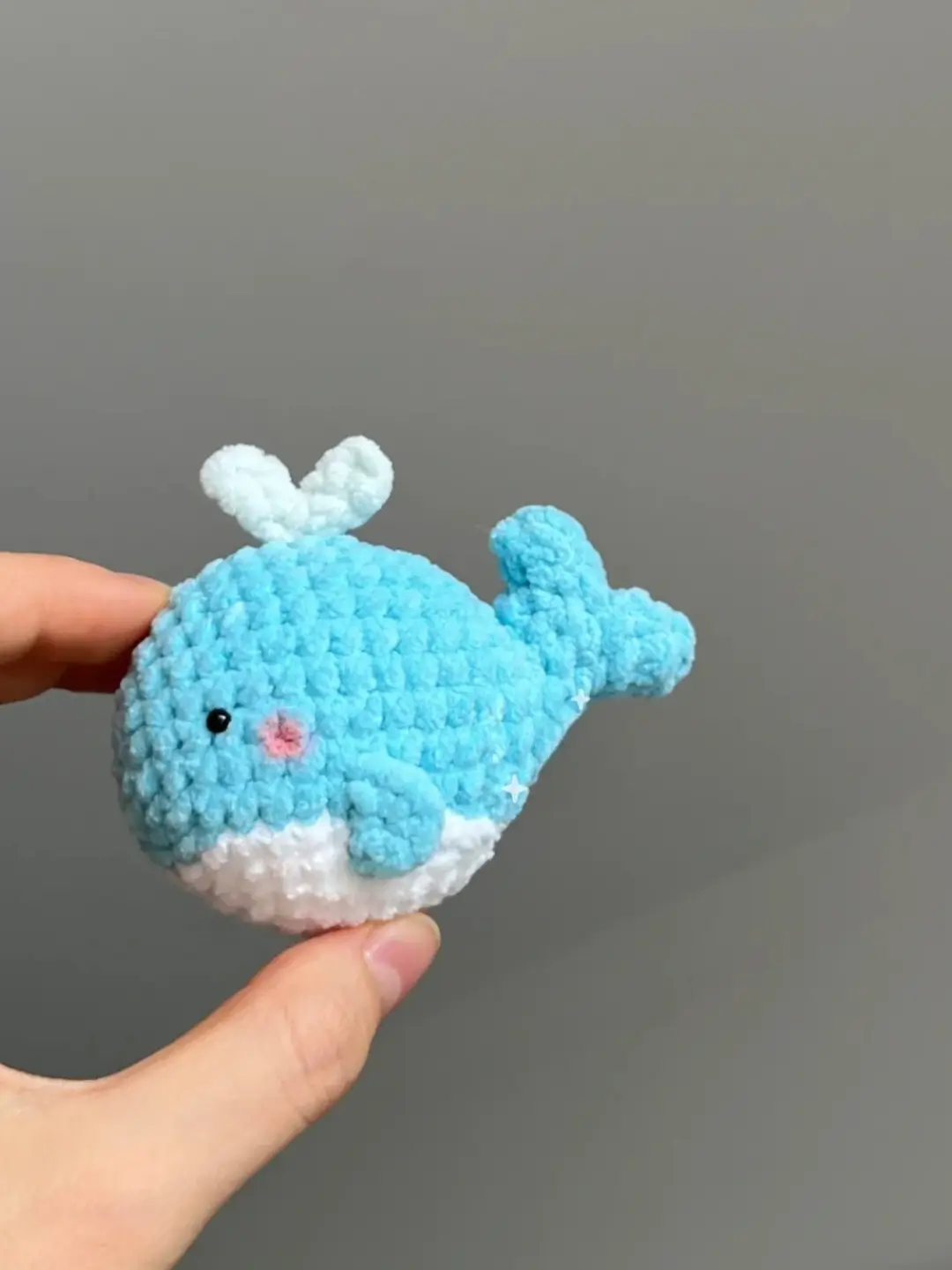Cute light blue crocheted whale toy.